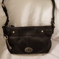 Black Leather Handbag Is New And Never Been Worn. Has Top Zip Closure With 1 Inside Zip Pocket And 2 Inside Open Pockets. Silver Hardware. Measures 7-3/4"Lx12-1/2"Wx1-1/2"D With 12" Shoulder Strap. Comes With Fossil Key (See 9th Picture) And Fossil Dust Bag (See Last Picture). Black Leather Handbag, Fossil Handbags, Fossil Bags, Black Leather Handbags, Leather Handbag, Silver Hardware, Leather Handbags, Fossil, Black Silver