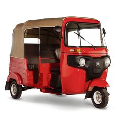 an old red and tan three wheeled vehicle on a white background with the door open