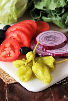 some vegetables are on a white cutting board