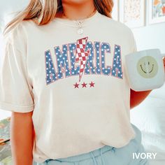 America  Shirt,Retro America Shirt, July Fourth Shirt, Comfort Colors, Patriotic Tee,America Freedom Shirt,Red White Blue Merica Shirt 1478 COMFORT COLORS - ADULT UNISEX - SHORT SLEEVE T-SHIRT - 1717 6.1 oz./yd² (US), 10 oz/L yd (CA), 100% ring-spun cotton, 30 singles Garment dyed for that lived in feel and almost no shrinkage at home. Soft ring-spun cotton fabric with 100% cotton threads Relaxed fit Topstitched, classic width, rib collar Shoulder to shoulder twill tape Signature twill label Made With Respect Proud member of the U.S. Cotton Trust Protocol Made with OEKO-TEX certified low-impact dyes Our clean pigment dye colors are salt free This product meets the following Sustainable Style subcategories: Sustainable Manufacturing  Socially Conscious Manufacturing Shade variations are inh Merica Shirt, Freedom Shirts, Patriotic Tees, 30 And Single, Unisex Shorts, Red White Blue, Twill Tape, Sustainable Fashion, Comfort Colors