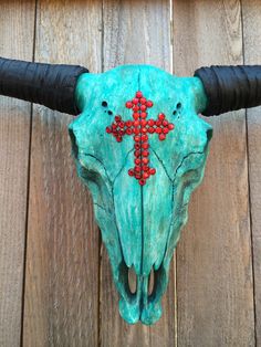 a cow skull with a cross painted on it