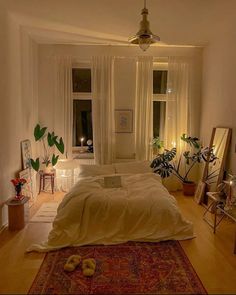 a bedroom with a large bed and lots of plants