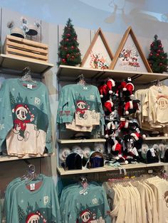 there are many christmas sweaters on display in the store, including one with a snowman