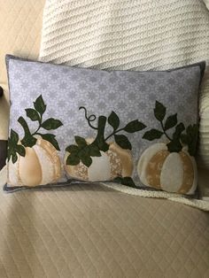 a decorative pillow with pumpkins on it