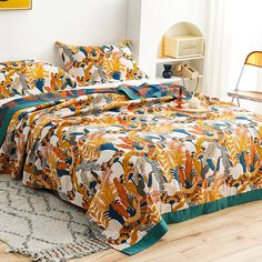 a bed covered in a colorful comforter and pillows