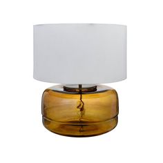 a yellow glass table lamp with a white shade on it's top and bottom