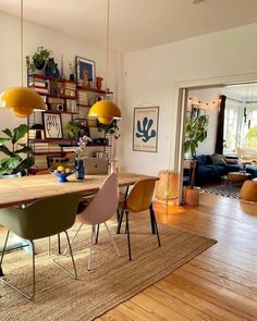 a dining room table with chairs and plants on it