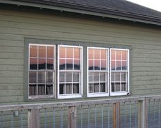 three windows on the side of a building