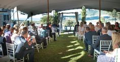 a group of people sitting in chairs under a tent