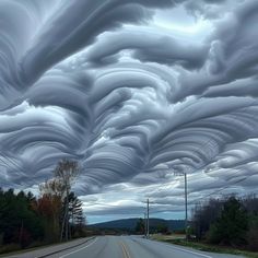 a long line of clouds over a road