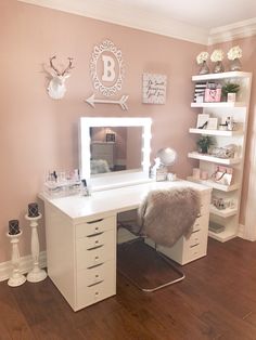 a white desk with drawers and a mirror on top of it in a pink room