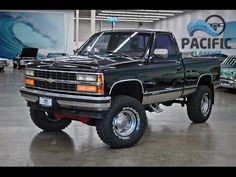 a large black truck parked in a garage