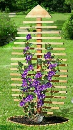 a wooden planter with purple flowers in it and the words click here to view more