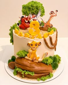 the lion king birthday cake is decorated with fondant animals