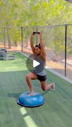 a woman is doing exercises on an exercise ball in the middle of a tennis court