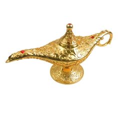 an ornate brass oil lamp on a white background