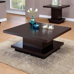 a living room filled with furniture and a lamp on top of a coffee table in front of a window