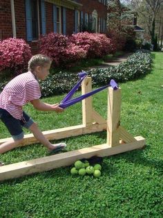 a young boy is playing with some toys in the grass and on the ground outside