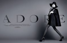 a woman in a black coat and fishnet stockings is posing for adore magazine