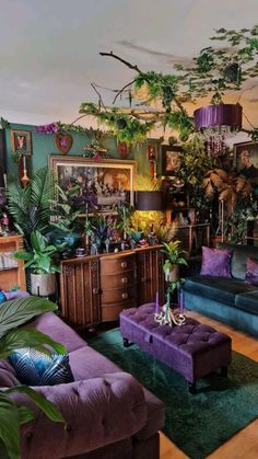 a living room filled with purple couches and lots of greenery on the walls