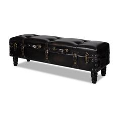 a black leather trunk sitting on top of a wooden table