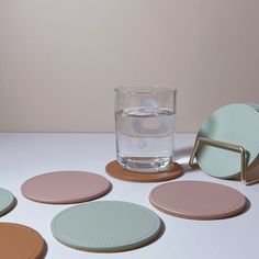 several coasters and a glass on a table