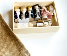 a box filled with lots of different types of shoes next to a burlap bag