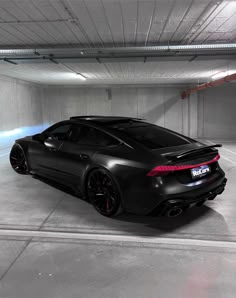 a black sports car parked in a parking garage