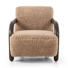 the chair is made out of sheepskin and has wooden legs, it's upholstered with an armrest