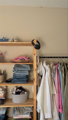 an organized closet with clothes and shoes