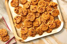 a pan filled with cookies sitting on top of a counter next to a towel and napkin