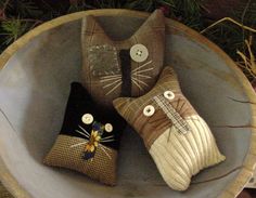 three decorative pillows are sitting in a bowl