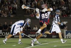 lacrosse players in action on the field during a game