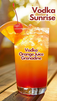 an orange and red drink sitting on top of a wooden table