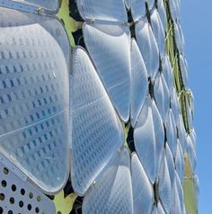 a close up view of the side of a building made out of plastic plates and metal rivets