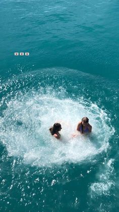 two people in the water on a boat