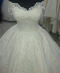 a white wedding dress on display in a store