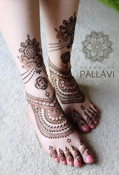 the legs and feet of a woman with henna tattoos