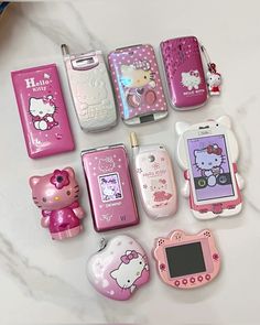 there are many hello kitty cell phones on the counter top, including one for girls and one for boys