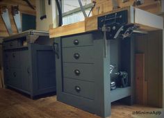 a kitchen with an island made out of cabinets and drawers in the middle of it