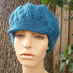 a mannequin head wearing a blue knitted hat