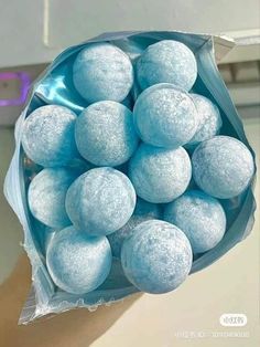 a blue bag filled with lots of snowballs