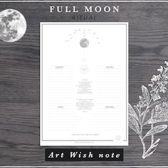 an art wish note with a full moon in the background on a wooden table top