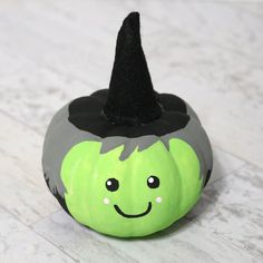 a painted pumpkin with a witches hat on it