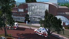 two ambulances are parked in front of a hospital