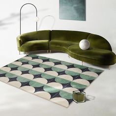 a green couch sitting on top of a rug in a living room next to a lamp