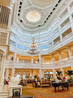 a large lobby with chandelier and piano in it