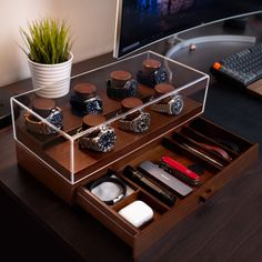 a desk with a computer monitor, keyboard and various accessories