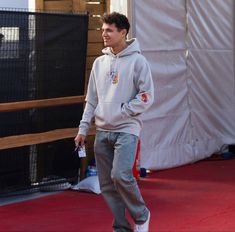 a young man is skateboarding on the red carpet