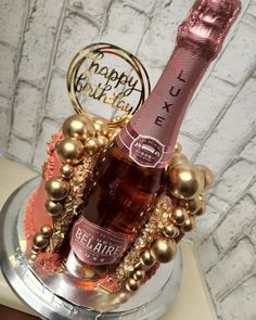 a birthday cake with a bottle of champagne on top